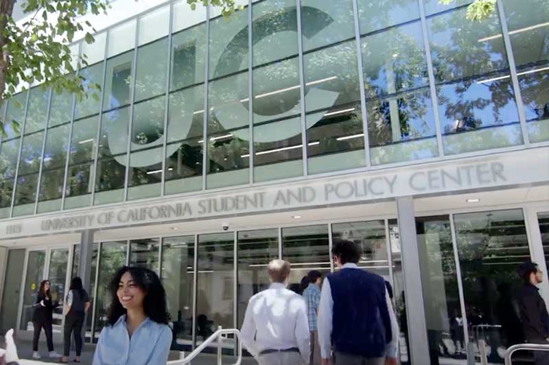 Entrance of the University of California Student and Policy Center with people walking in.